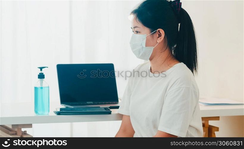 Asian woman using alcohol gel hand sanitizer wash hand before open tablet for protect coronavirus. Female push alcohol to clean for hygiene when social distancing stay at home and self quarantine time