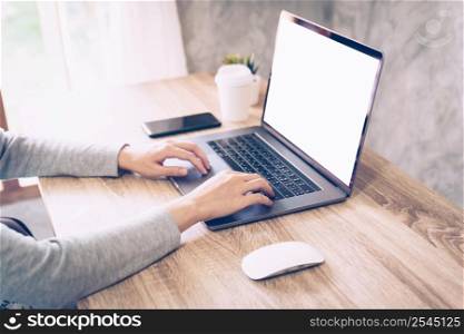 Asian woman using computer laptop for working on wooden table