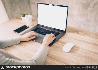 Asian woman using computer laptop for working on wooden table