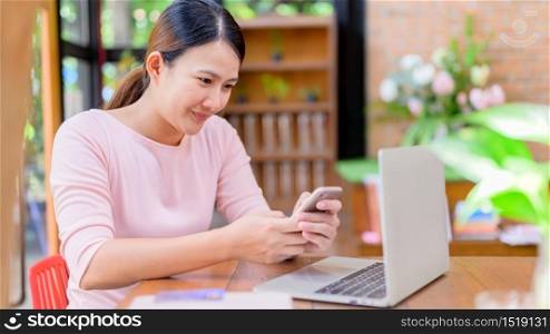 Asian woman using credit card for online shopping and home delivery. New normal life after COVID-19. Stay home and Social Distancing.