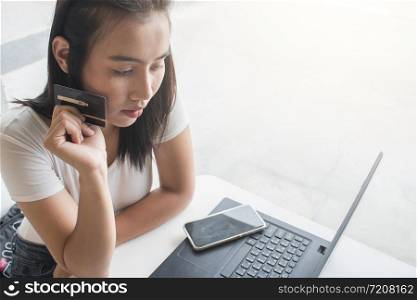 Asian woman using credit card shopping online