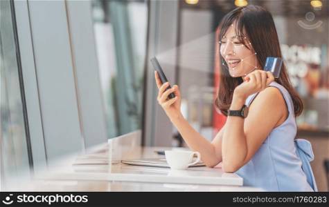 Asian woman using face recognition via smart mobile phone indoors, Biometric Verification and artificial intelligence, online shopping and payment online concept