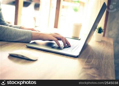 asian woman using laptop computer do online activity on wood table at home office.