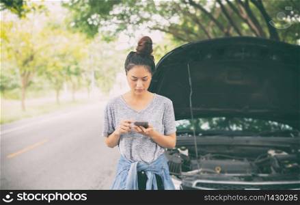 Asian woman using mobile phone while looking and Stressed man sitting after a car breakdown on street