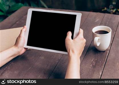 Asian woman using tablet on table in coffee shop with vintage toned.
