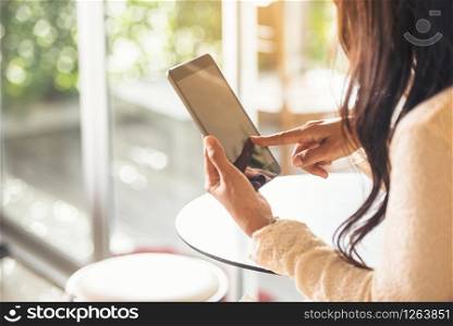 Asian woman using tablet shopping online website on smart tablet hand point touch screen digital tablet. Woman holding smartphone checking mail online shopping website read article vlog social media