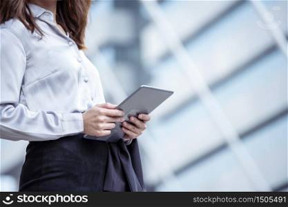 Asian woman using tablet shopping online website on smartphone with smiling face. Happiness asian woman holding cellphone checking mail from online shopping website read article Blog vlog social media
