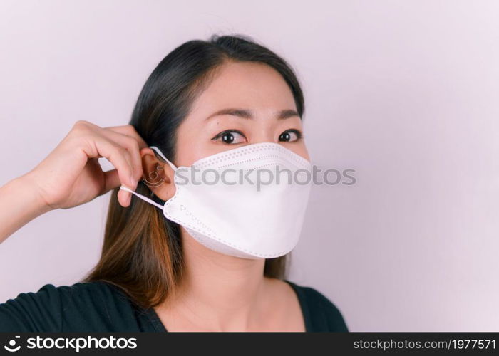 Asian woman wearing a white mask, close-up