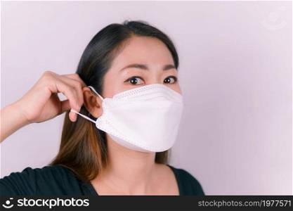 Asian woman wearing a white mask, close-up