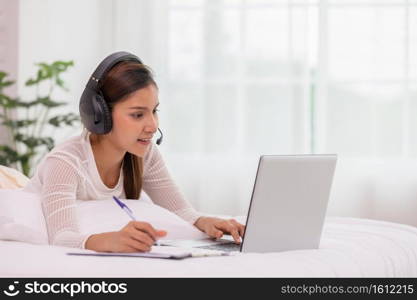 Asian woman wearing earphone and meeting in VDO call conferennce