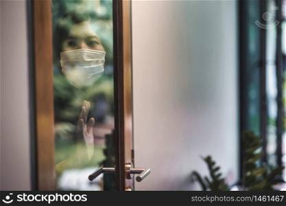 Asian woman wearing medical mask stay isolation at home for self quarantine in Covid-19 outbreak situation, coronavirus pandemic and lockdown, Social distancing and responsibility, new normal concept
