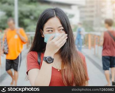 asian woman wearing protective mask against virus and air pollution in public.