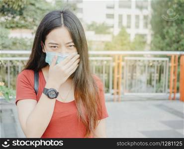 asian woman wearing protective mask against virus and air pollution in public.