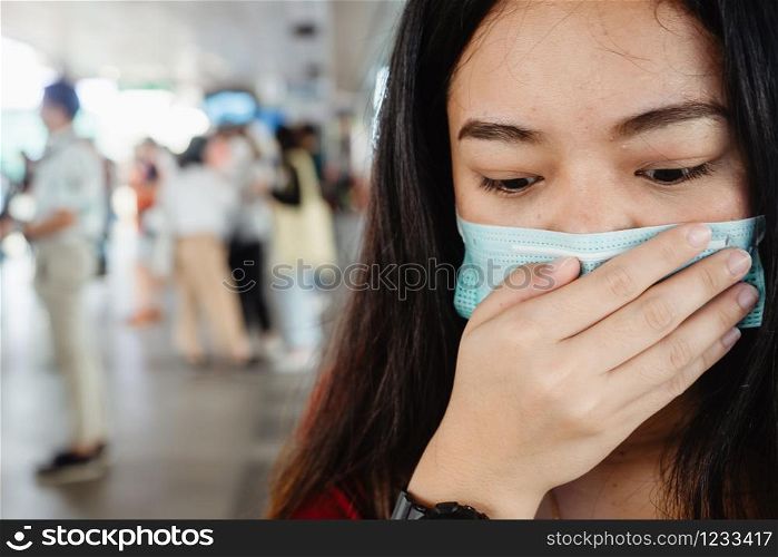 asian woman wearing protective mask against virus and air pollution in public transport.