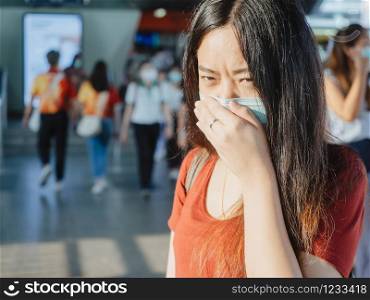asian woman wearing protective mask against virus and air pollution in public transport.