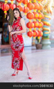 Asian woman wearing red cheongsam dress traditional decoration with paper lanterns with the Chinese alphabet Blessings written on it Is a Fortune blessing compliment for Chinese new year festival