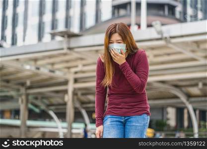 Asian woman wearing safety medical face mask for prevent Coronavirus or Covid19 Outbreak, coughing when travel to work in business downtown, Health care and infection concept