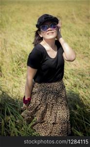 asian woman wearing sun glasses toothy smiling face happiness emotion standing outdoor