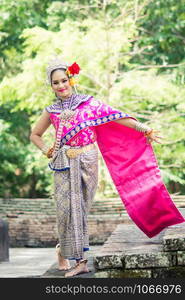 Asian woman wearing typical, traditional Thai Dress. It is literally means