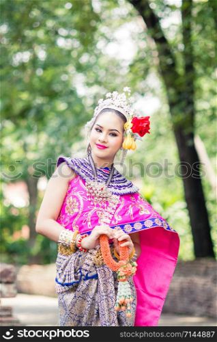 Asian woman wearing typical, traditional Thai Dress. It is literally means
