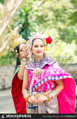 "Asian woman wearing typical, traditional Thai Dress. It is literally means "Thai outfit", National costume."