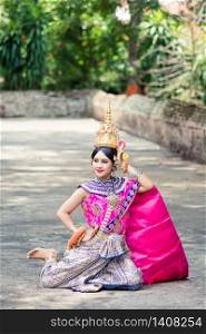 "Asian woman wearing typical, traditional Thai Dress. It is literally means "Thai outfit", National costume."