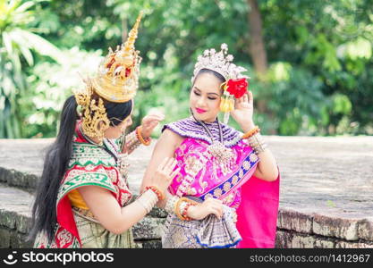 "Asian woman wearing typical, traditional Thai Dress. It is literally means "Thai outfit", National costume."