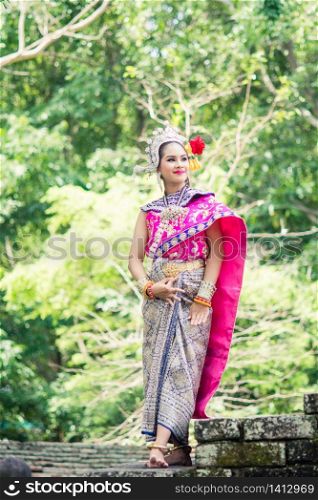 "Asian woman wearing typical, traditional Thai Dress. It is literally means "Thai outfit", National costume."