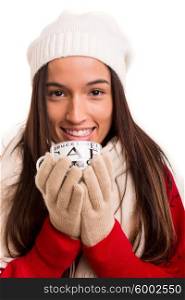 Asian woman wearing winter clothes and holding a cup of tea or coffee