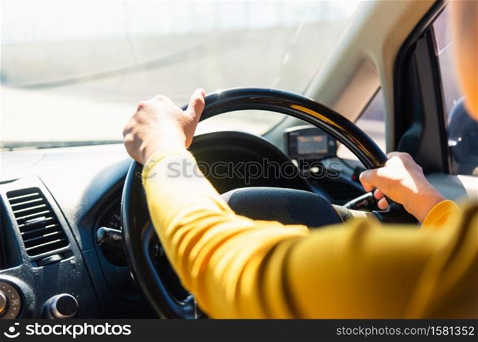 Asian woman while driving the car in the morning during going to work on highway road, Transportation and vehicle concept