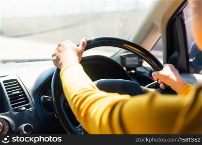 Asian woman while driving the car in the morning during going to work on highway road, Transportation and vehicle concept
