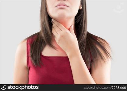 Asian woman with a sore throat or thyroid gland against the gray background. Acid reflux or Heartburn, Neck pain, People body problem concept