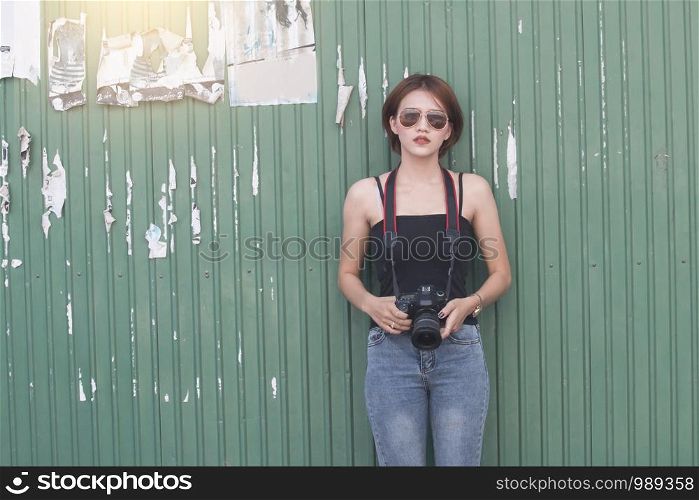 Asian woman with camera while she's travelling