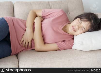 asian woman with menstruation and pain period cramps. young women having painful stomachache.