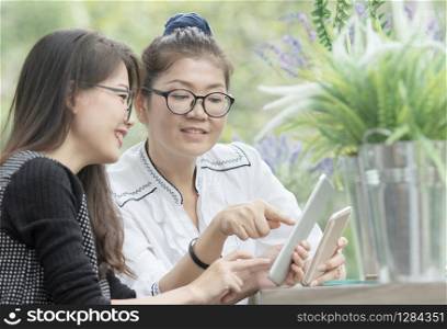 asian woman with mobile phone in hand talking with relaxing emotion