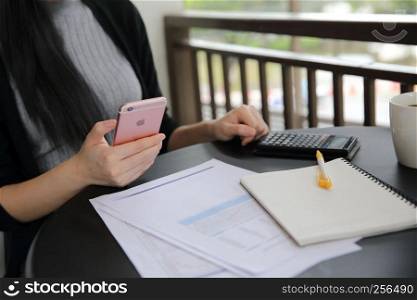 Asian woman with smart phone with business