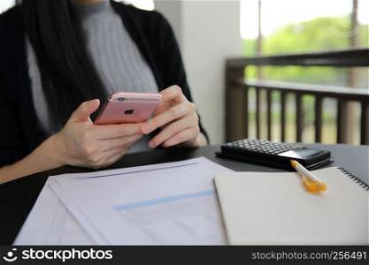 Asian woman with smart phone with business
