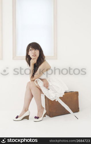 Asian woman with suitcase