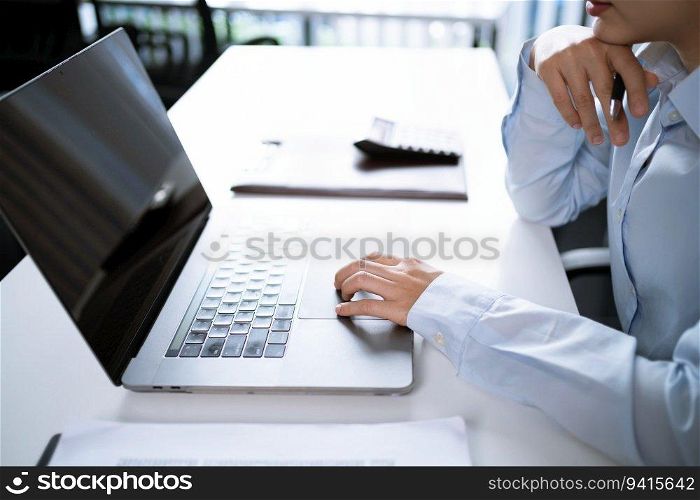 Asian Woman working by using a laptop computer Hands typing on keyboard. Working at office professional investor working new start up project
