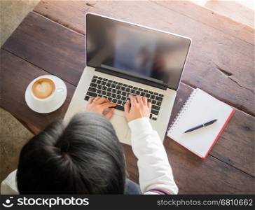 Asian woman working online with wireless gadget, stock photo