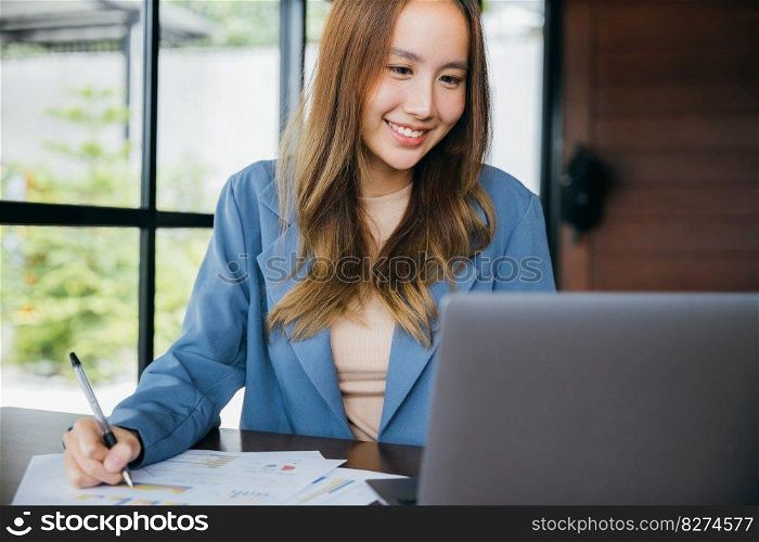 Asian woman working with laptop computer she analyst financial advisor preparing statistic report studying documents, Businesswoman audit financial charts and graphs