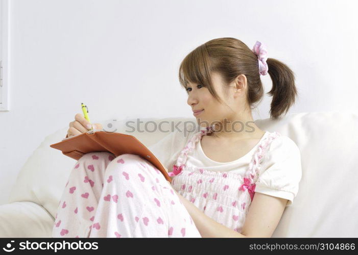 Asian woman writing