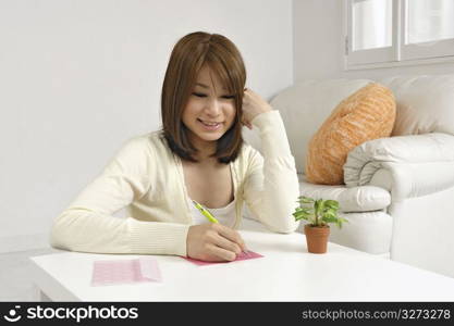 Asian woman writing