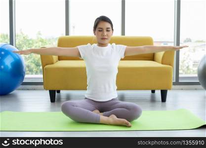 Asian woman yoga exercising at home