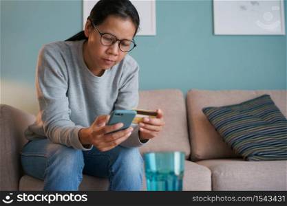 Asian women are buying online with a credit card. woman are using a smartphone and doing online transactions, Concept of shopping on the online store and fast delivery