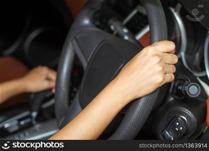 Asian women are driving cars on the road.
