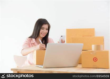 Asian women are smiling and recording customer orders,business online marketing concept