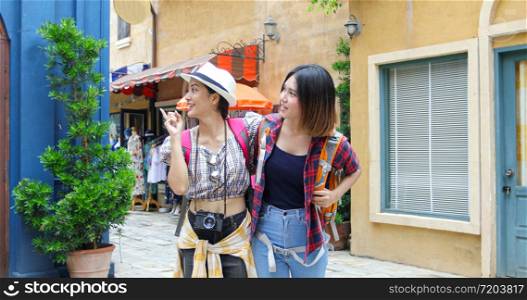 Asian women backpacks walking together and happy are taking photo and looking picture ,Relax time on holiday concept travel