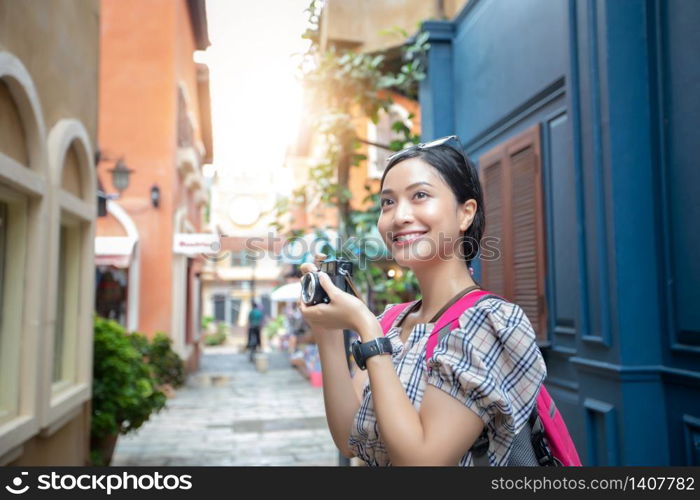 Asian women backpacks walking together and happy are taking photo and selfie ,Relax time on holiday concept travel