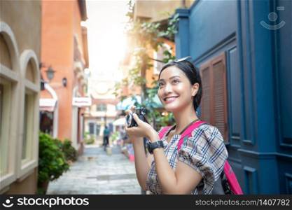 Asian women backpacks walking together and happy are taking photo and selfie ,Relax time on holiday concept travel